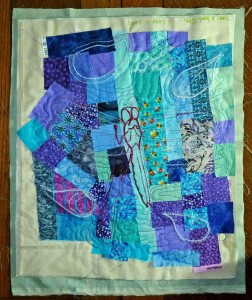 Stitched dragonfly and random satin-stitched shapes, free motion quilted.