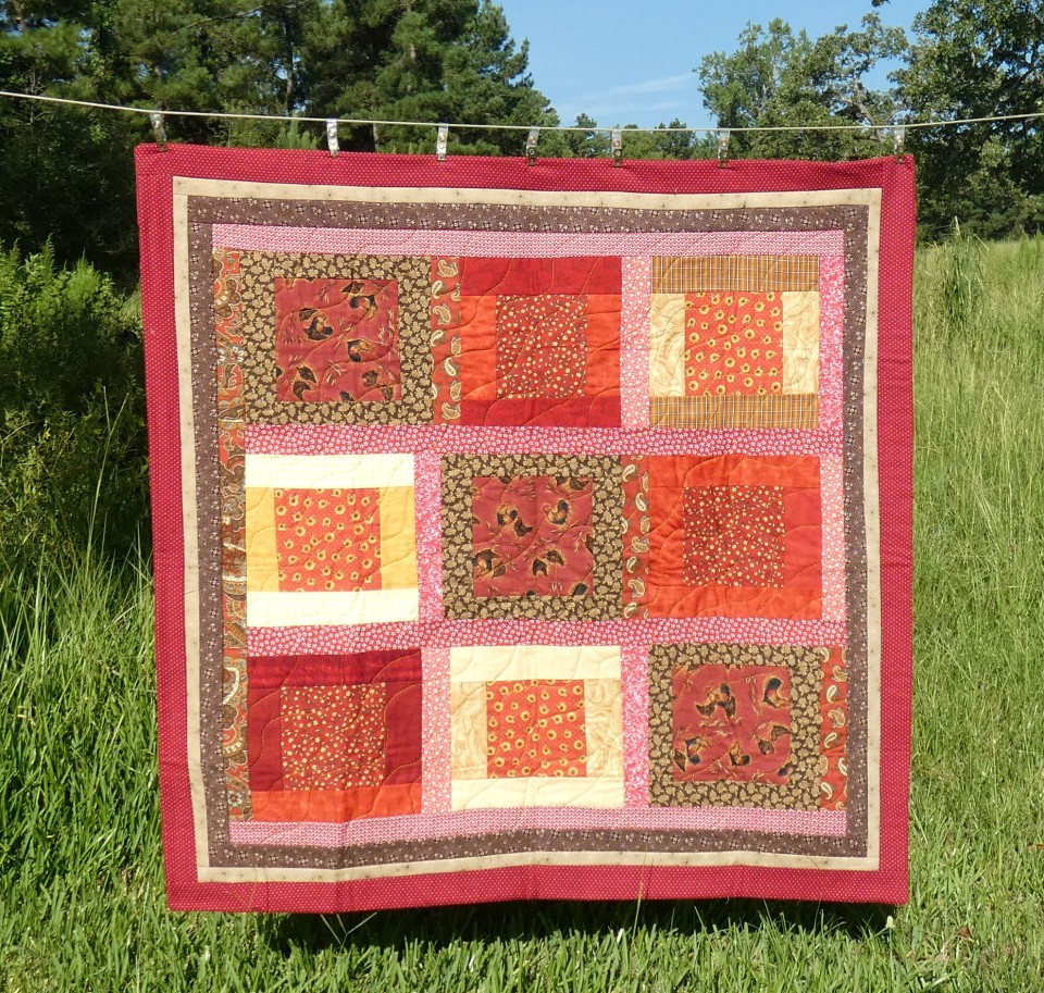 lap quilt in reds and browns